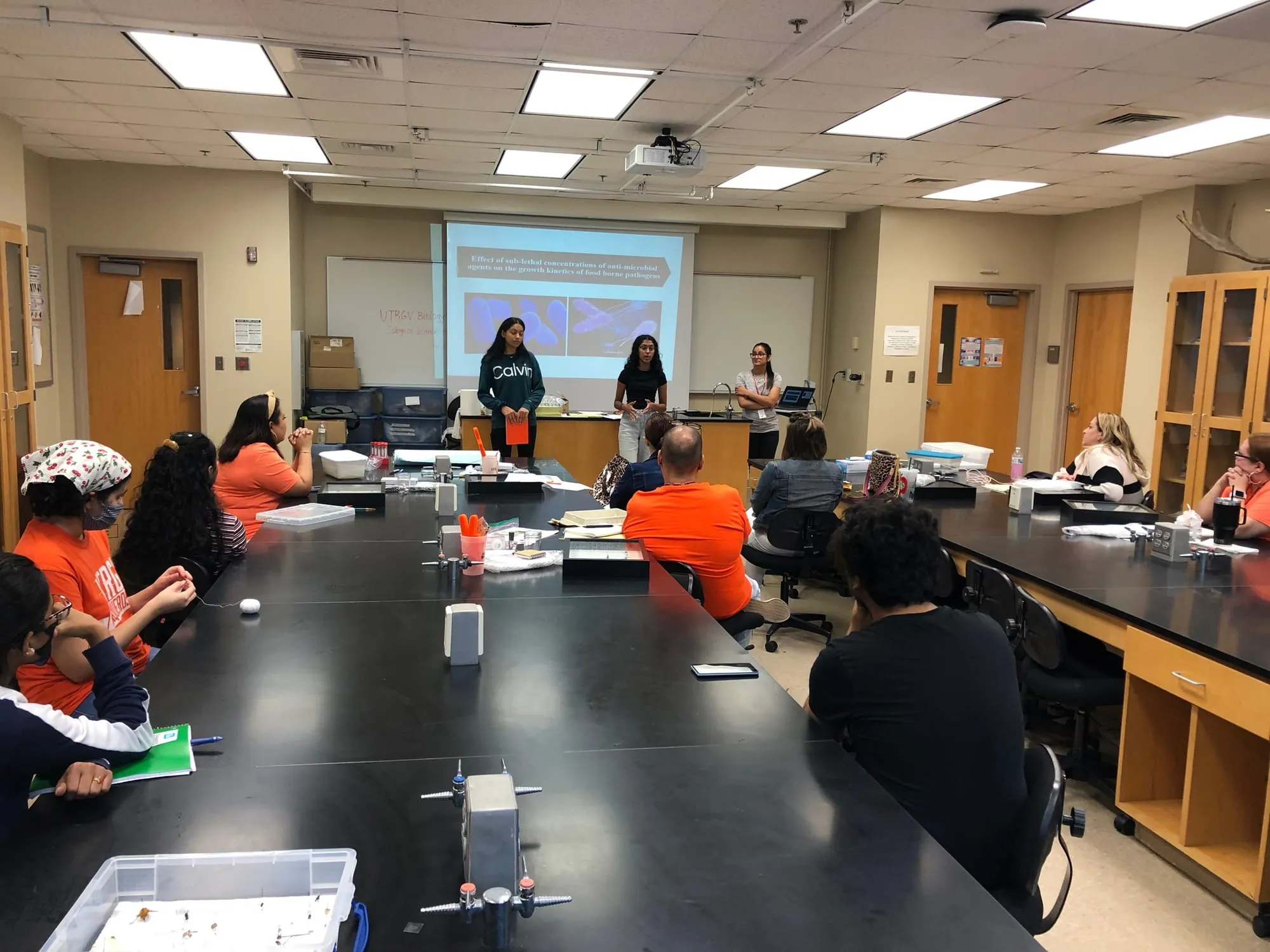 High school teachers attending a workshop where students presenting their work