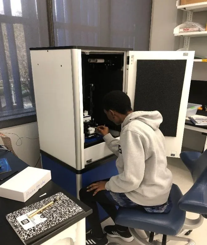 Student operating an analytical instrument
