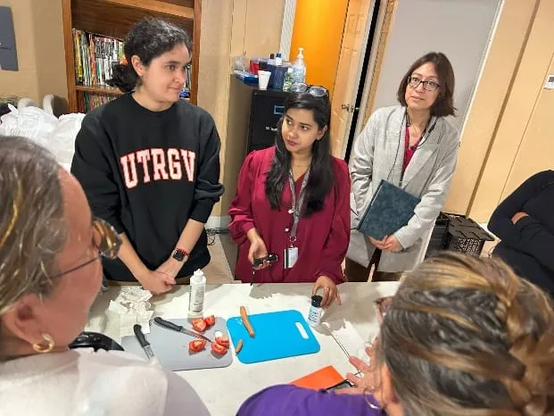 Students demonstrating a hands-on activity to visitors